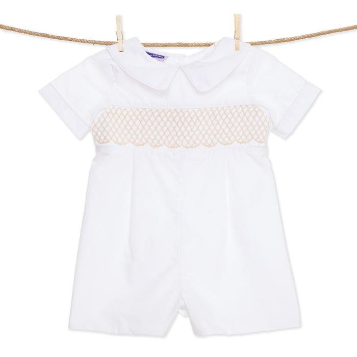 A white shortall with cream smocking and collar for babies