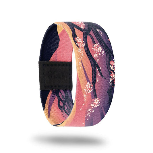 Outside design for Spirited Away. blended pink and light orange background with a cherry blossom branch with a few small flower blooms