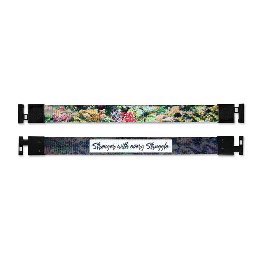 Shows outside and inside design for Stronger With Every Struggle imperial with black aglet clasps. Top is the outside design, a realistic image of a collection of colorful plant life. Bottom is the inside design, with a black background and a white box in the center with Stronger With Every Struggle in black text.