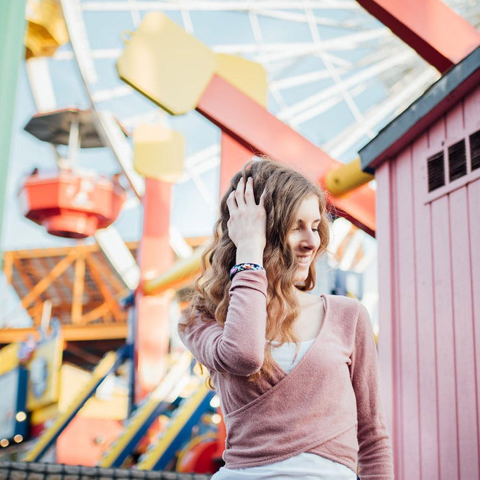 Lifestyle image of someone in front of a ferris wheel wearing Stronger With Every Struggle
