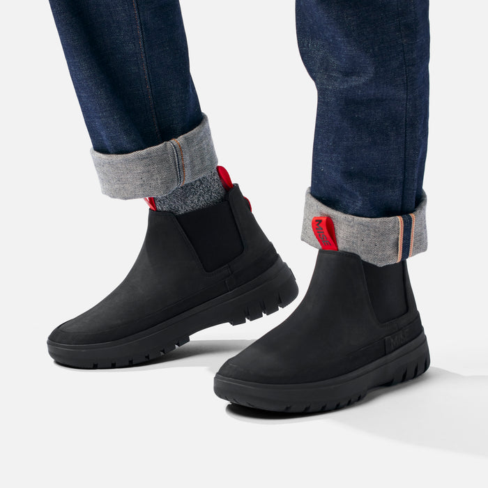 MISE Chelsea boot black slip-resistant kitchen shoe on foot side view on light gray background