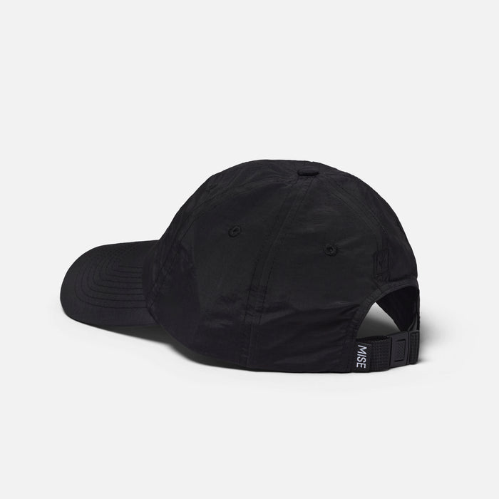 The Dad Cap gallery position 1 showing black moisture-wicking 6-panel cap rear with adjustable MISE strap detail