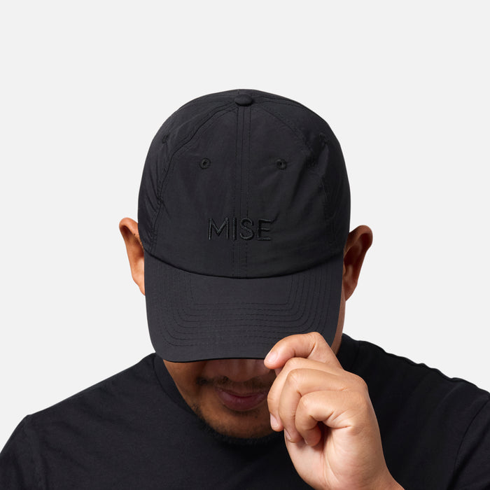 The Dad Cap gallery position 1 showing front view with black embroidered MISE logo on moisture-wicking fabric
