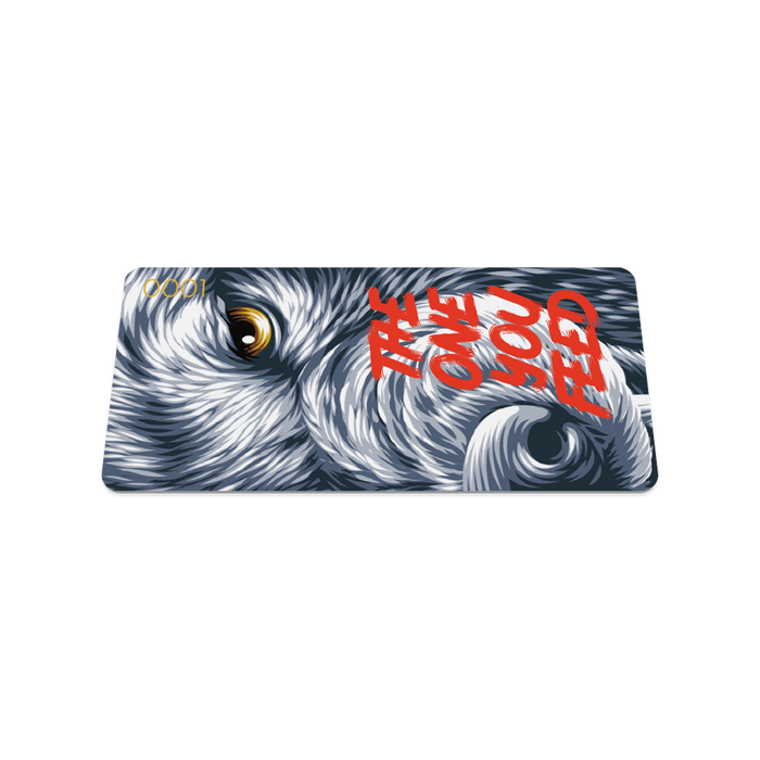 Front collector's card image of The One You Feed: half a grey wolf's face with sharp yellow eyes and an opened red mouth with red text 'The One You Feed'