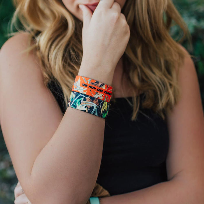 Lifestyle photo of girl wearing two The Path Less Traveled straps showing the inside and outside design