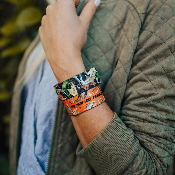 Lifestyle photo of girl holding onto jacket wearing two The Path Less Traveled straps showing the inside and outside design