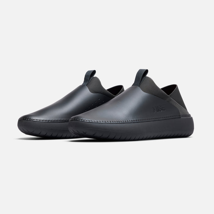 MISE Relaxed 2 angled front view showing sleek black slip-resistant kitchen shoes.