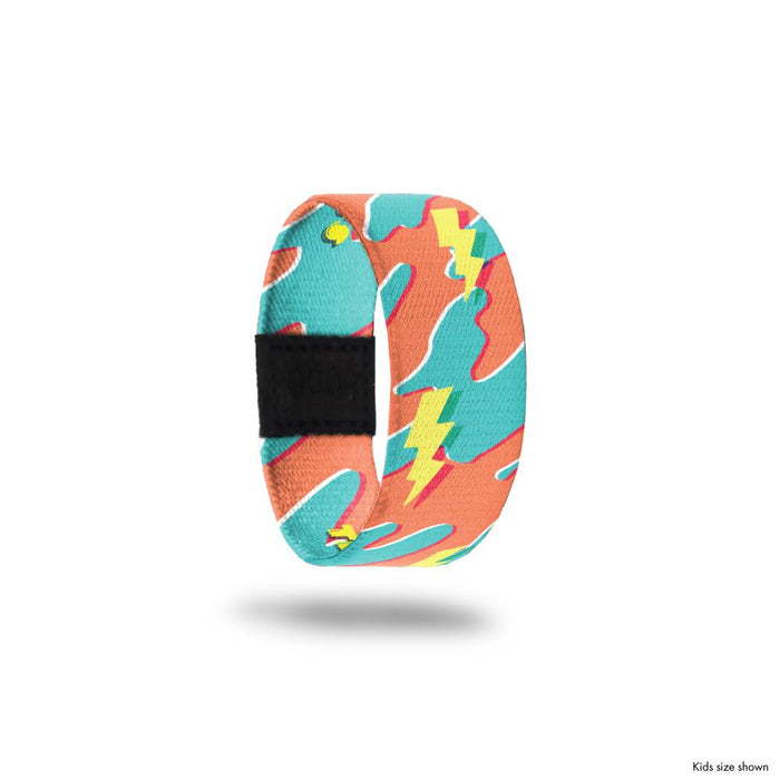 Kid size outside design for The Storm Will Pass. An orange and blue camouflage background with yellow drawn lighting bolt shapes