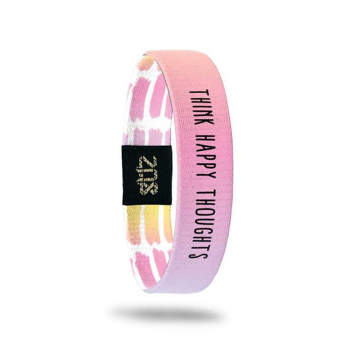 Inside Design of Think Happy Thoughts: watercolor gradient of orange, yellow, pink, purple, and blue background with black text overlaying ‘Think Happy Thoughts’