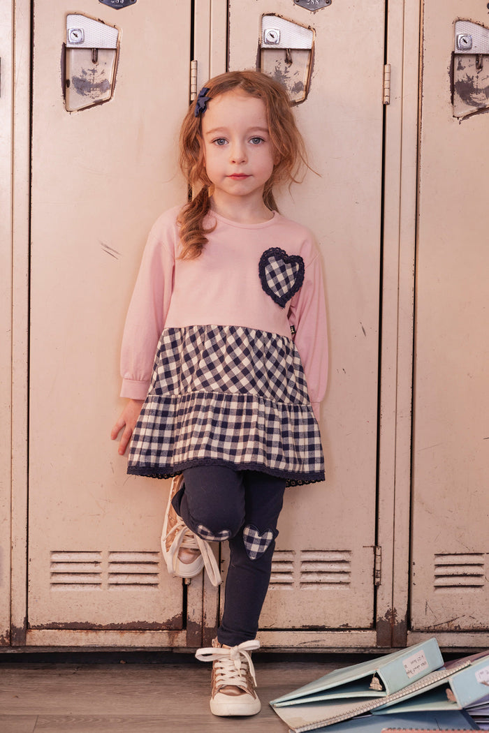 Child wearing the Deux par Deux pink tunic and navy leggings set