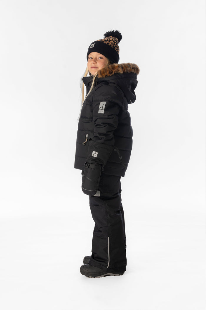 Child wearing the black Deux par Deux PLAY snowsuit with leopard faux-fur trim, side view