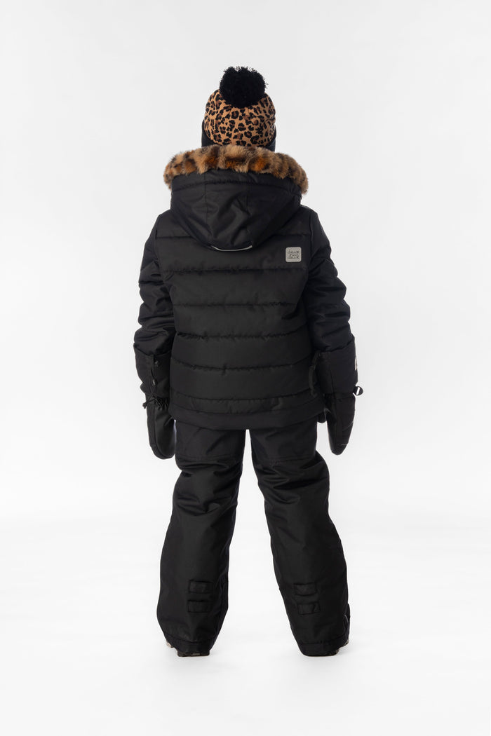 Child wearing the black Deux par Deux PLAY snowsuit with leopard faux-fur trim, back view