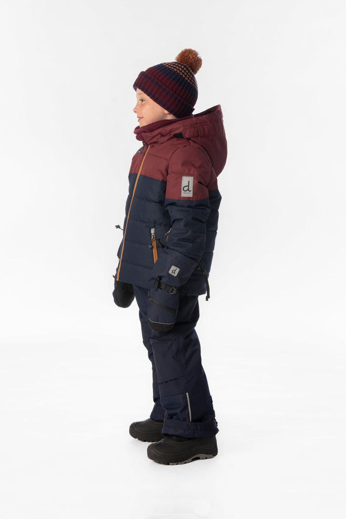 Child wearing the navy and burgundy Deux par Deux PLAY snowsuit, side view