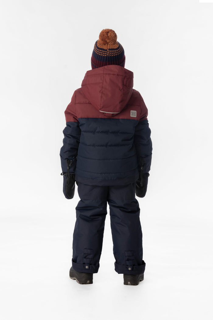 Child wearing the navy and burgundy Deux par Deux PLAY snowsuit, back view