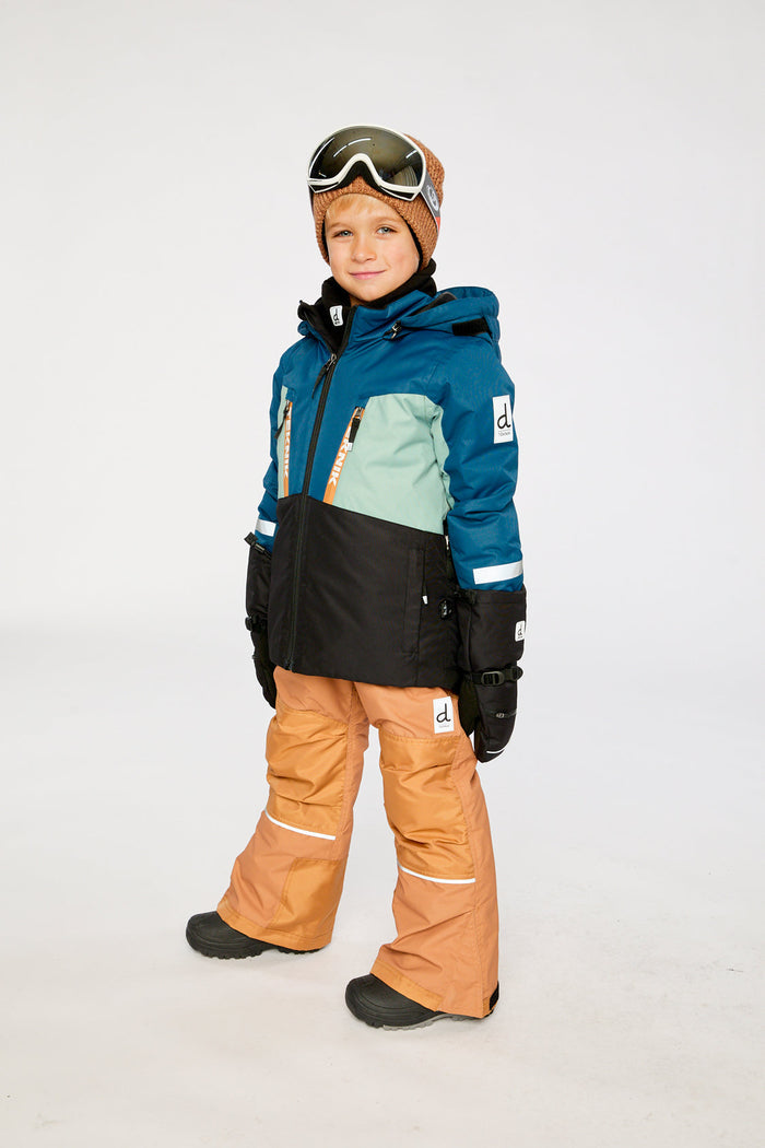 Child in the navy and tan TEKNIK snowsuit, three-quarter view
