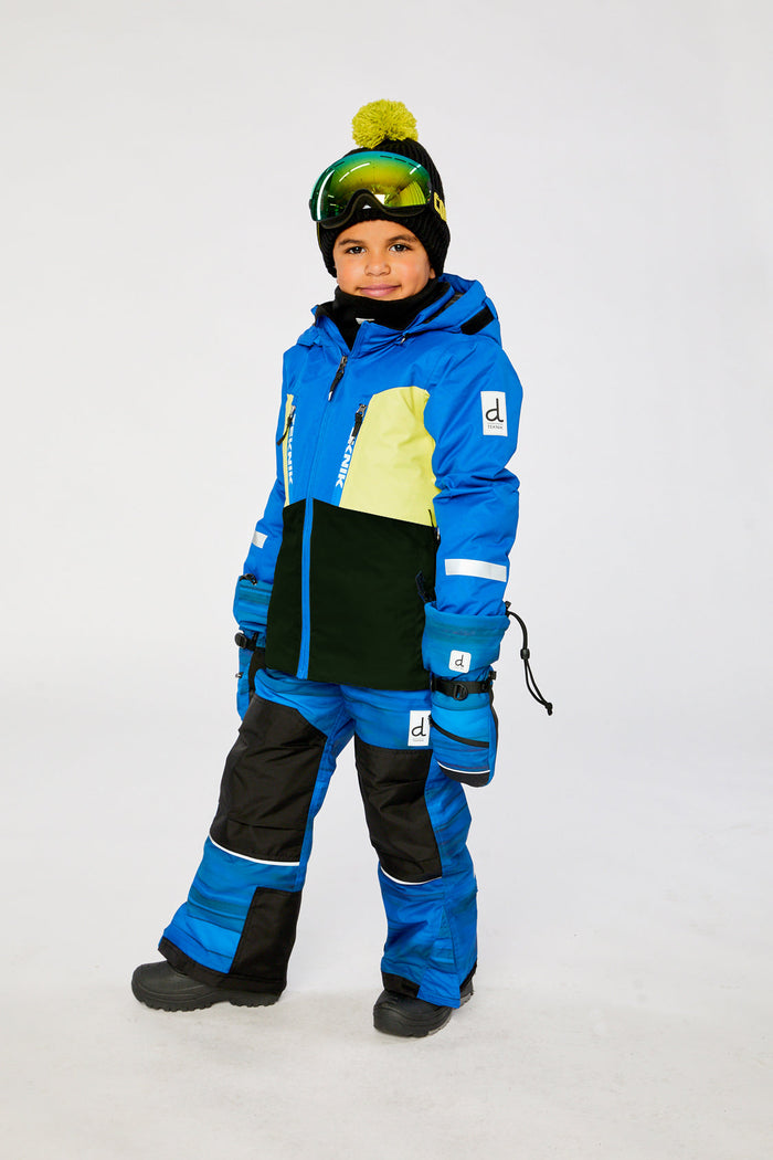 Child in the royal blue and yellow TEKNIK snowsuit, three-quarter view