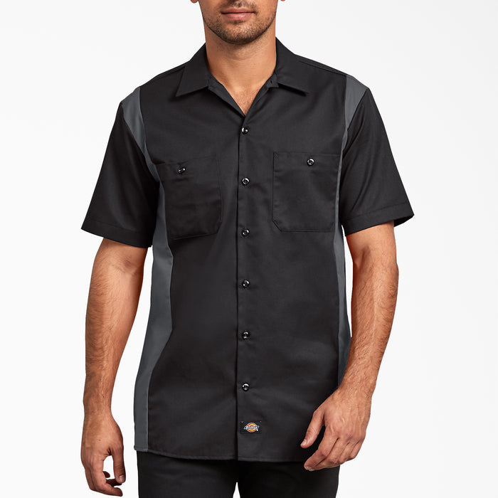Man wearing black and gray short-sleeve work shirt with dual chest pockets and button front closure.