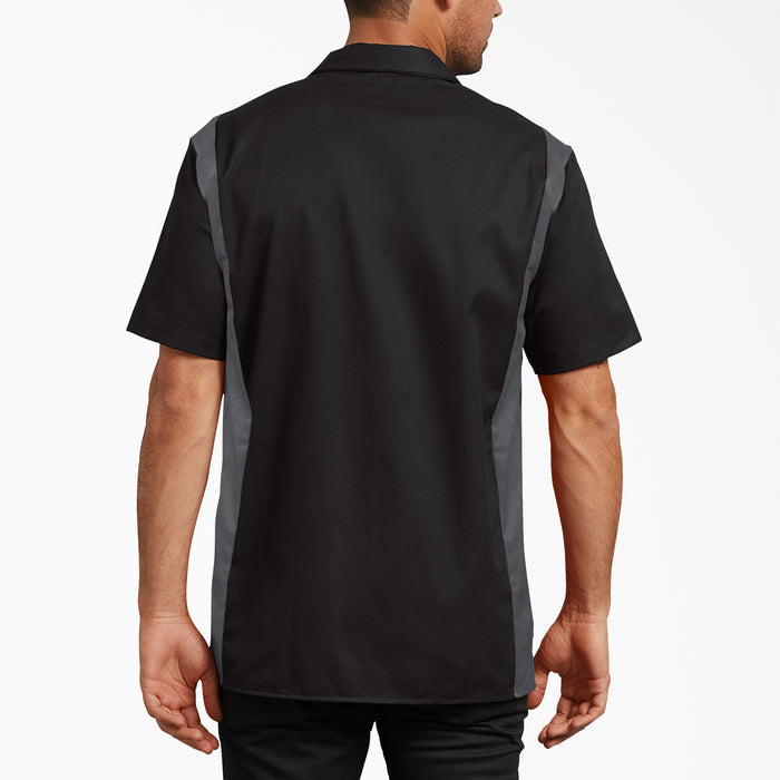 Black and gray short sleeve work shirt with contrasting side panels, shown from back view on male model.