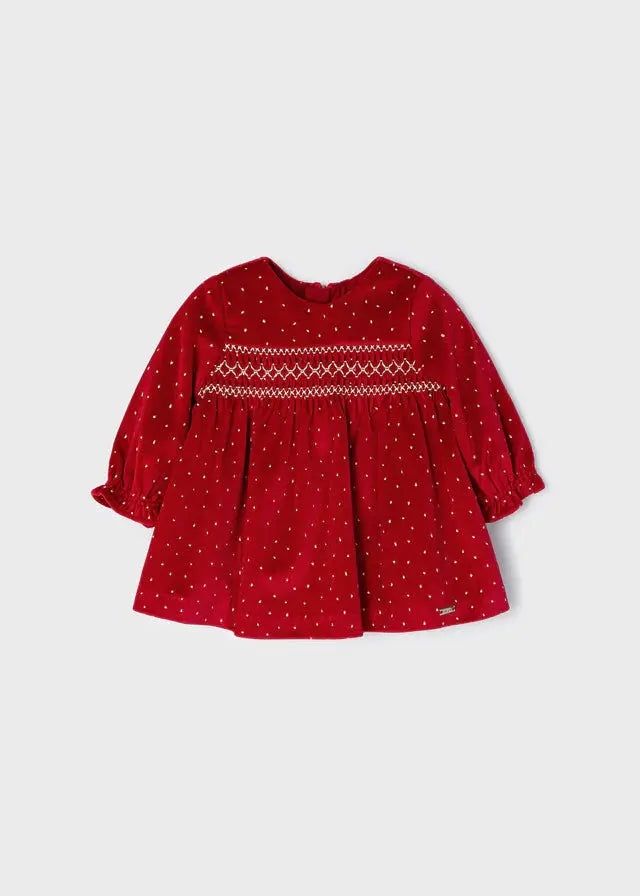 Front view of red Mayoral baby girl velvet dress with tiny cream dots and smocked chest