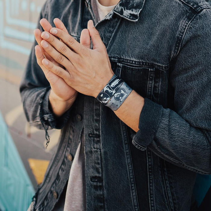 lifestyle photo of a front facing and inside facing Veteran wristband while a man puts his hands close together
