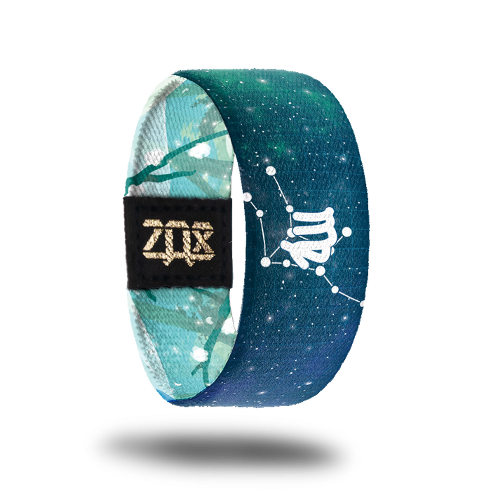 Inside design shows the Virgo symbol in the center of the strap while also having the astrological star formation behind it. Background is a blueish green tone with white dots symbolizing stars all over it.
