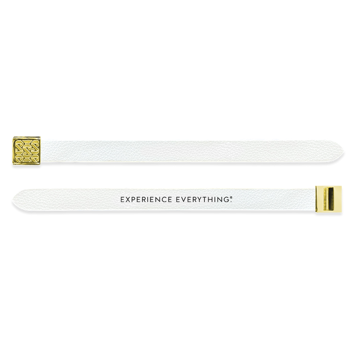 Outside Design of the V2 Imperial White Solid: vegan leather material with printed on white background and gold buckle clasp. And Inside Design of the V2 Imperial White Solid: vegan leather material with printed on white background with black text ‘Experience Everything’ and gold buckle clasp