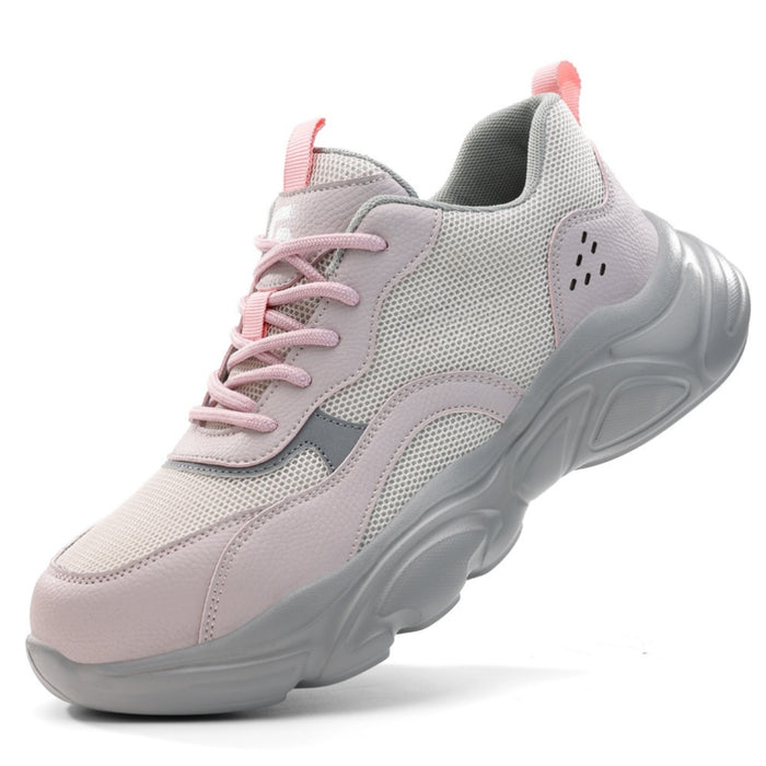 Side profile of SafeStep women's pink safety sneakers, featuring a breathable mesh upper, reinforced steel toe, and thick cushioned sole for athletic comfort.