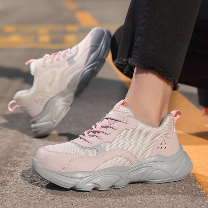 Outdoor lifestyle view of SafeStep women's pink steel toe safety sneakers, featuring a stylish mesh design and athletic fit for daily work wear.