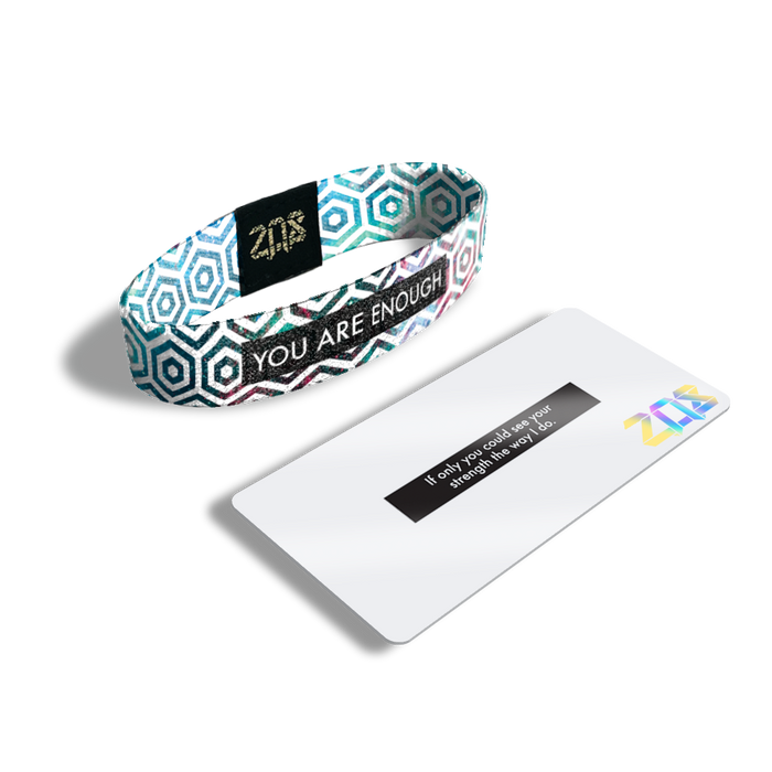 Product photo of the inside of you are enough. It is a white hexagon pattern overlaying a pink, blue, green, and purple galaxy design with white you are enough text over black box and its card that says ‘If only you could see your strength the way I do.’